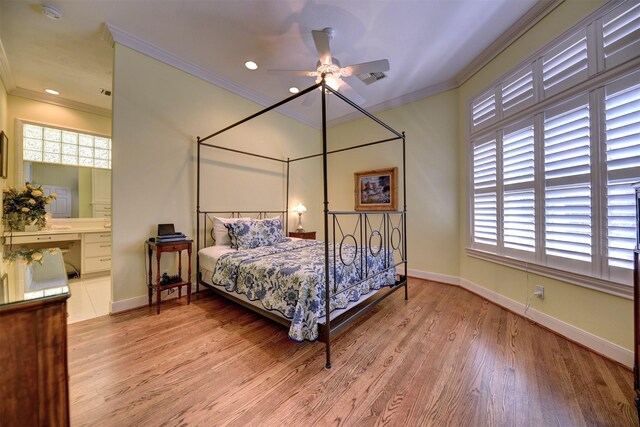 851 Elm Dr, Brenham, TX 77833 - bedroom with wood finished floors, crown molding, baseboards, ensuite bathroom, and recessed lighting
