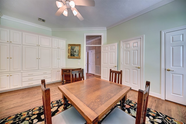 dining space with ornamental molding, light wood-type flooring, and ceiling fan