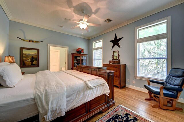 851 Elm Dr, Brenham, TX 77833 - bedroom featuring crown molding, light wood finished floors, baseboards, and a ceiling fan