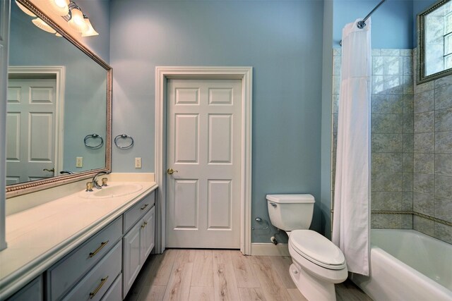 851 Elm Dr, Brenham, TX 77833 - full bath with toilet, vanity, wood finished floors, and shower / tub combo