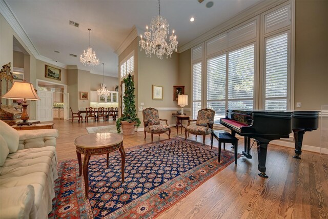 851 Elm Dr, Brenham, TX 77833 - living room featuring a chandelier, ornamental molding, wood finished floors, baseboards, and a high ceiling