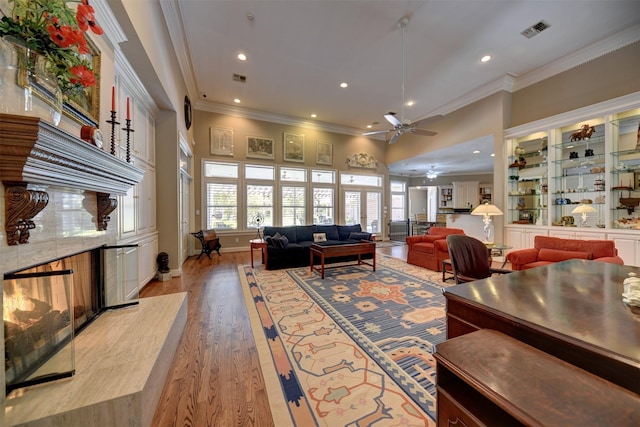 851 Elm Dr, Brenham, TX 77833 - living area with ornamental molding, a high end fireplace, recessed lighting, ceiling fan, and light wood-style floors