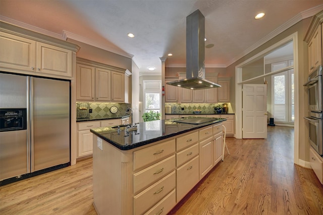 851 Elm Dr, Brenham, TX 77833 - kitchen featuring appliances with stainless steel finishes, island exhaust hood, ornamental molding, tasteful backsplash, and a center island