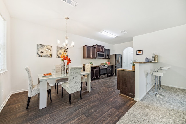 dining room featuring an inviting chandelier and dark wood-type flooring