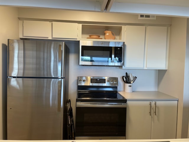 kitchen with white cabinetry and stainless steel appliances