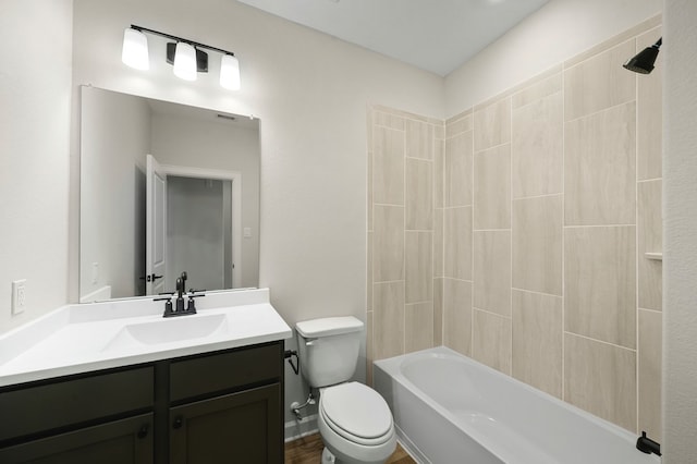 full bathroom featuring vanity, toilet, tiled shower / bath combo, and hardwood / wood-style floors