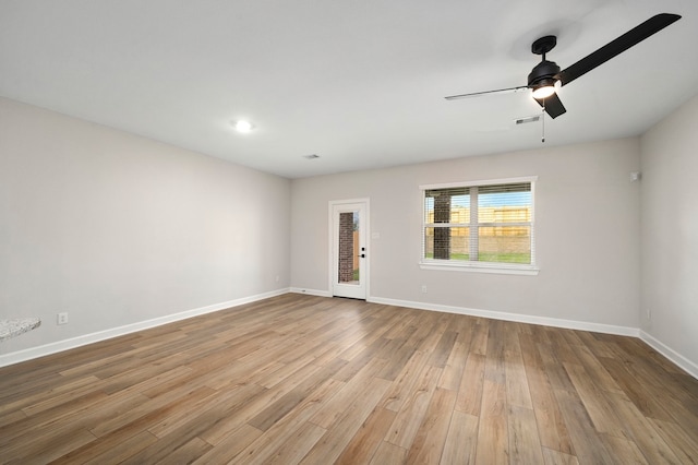 empty room with light wood-type flooring and ceiling fan