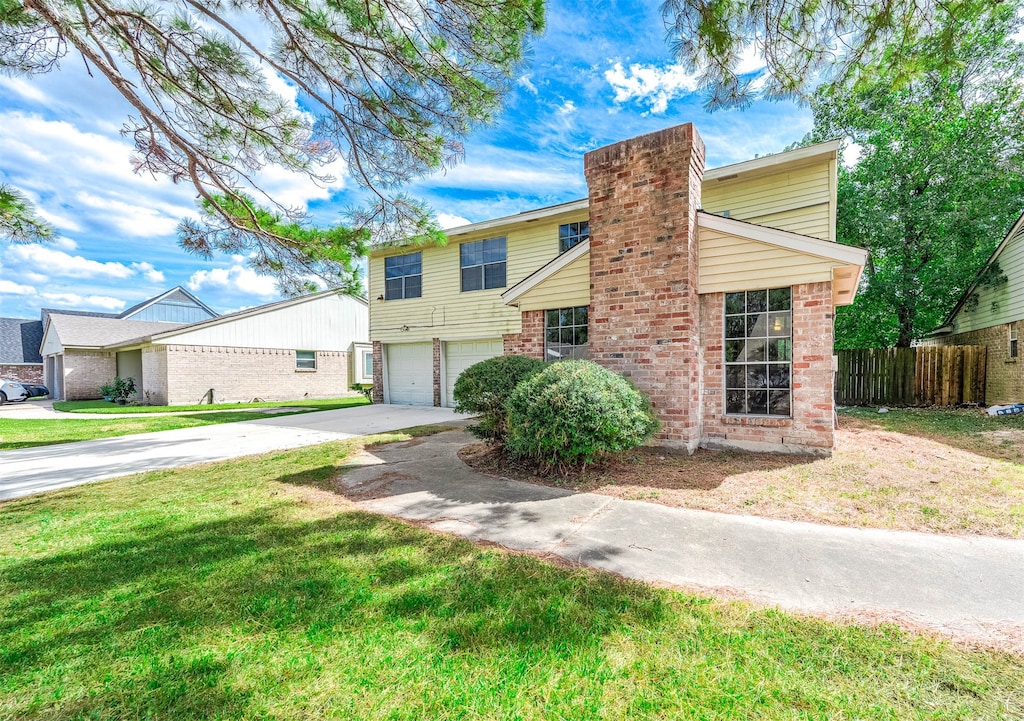 view of front of house featuring a front lawn and a garage