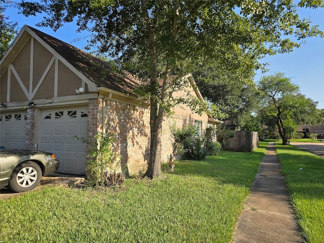 view of home's exterior featuring a yard and a garage