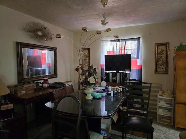 dining space with carpet flooring and a textured ceiling