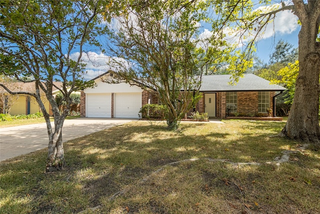 ranch-style house featuring a front yard and a garage