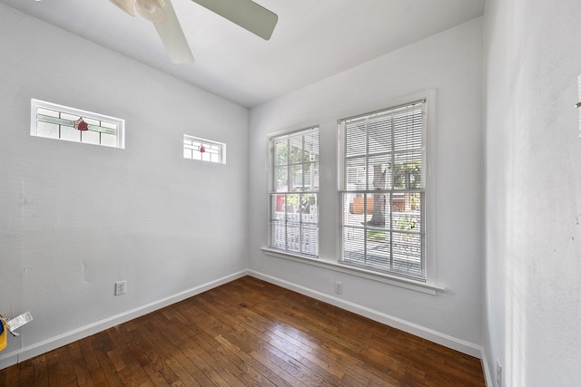 spare room featuring dark wood-type flooring and ceiling fan