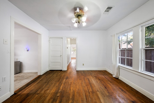 spare room with dark hardwood / wood-style floors and ceiling fan