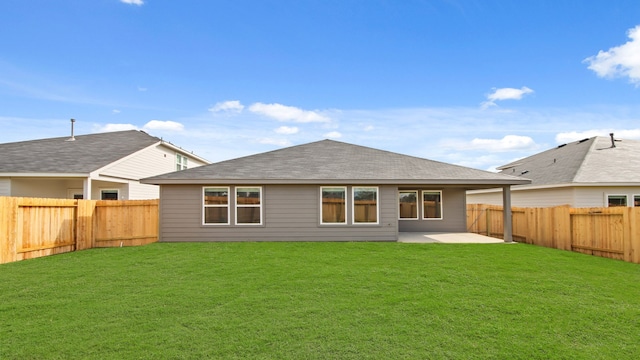 back of property with a yard and a patio