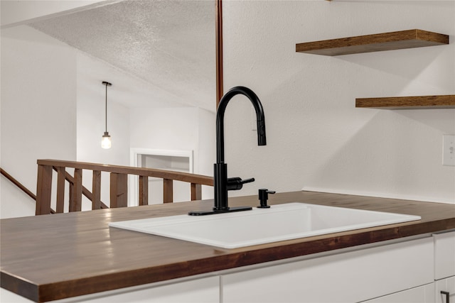 interior details with a textured ceiling and sink