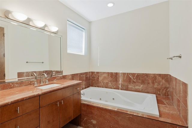 bathroom with vanity and tiled bath