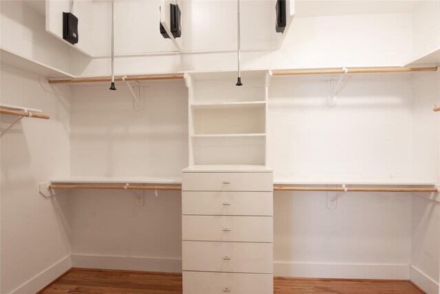 spacious closet with light hardwood / wood-style floors