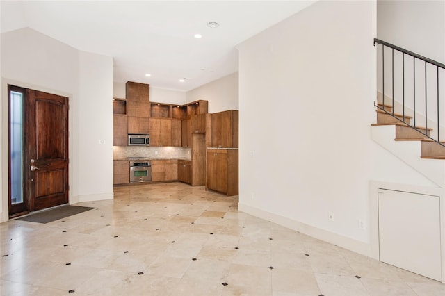 kitchen featuring stainless steel appliances and tasteful backsplash