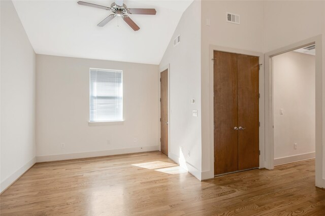 unfurnished room featuring ceiling fan, light hardwood / wood-style floors, and lofted ceiling