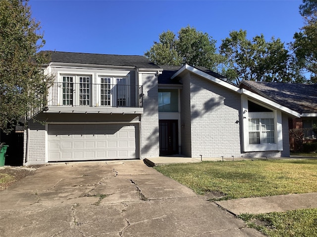 view of front facade with a garage, a balcony, and a front lawn