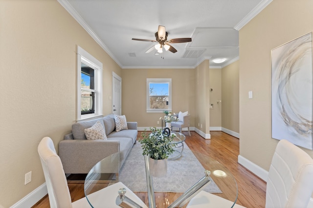 living room featuring ceiling fan, ornamental molding, and hardwood / wood-style floors