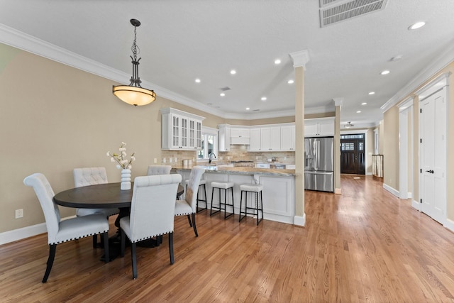 501 Cordell St, Houston, TX 77009 - dining area with crown molding, a wealth of natural light, visible vents, and recessed lighting