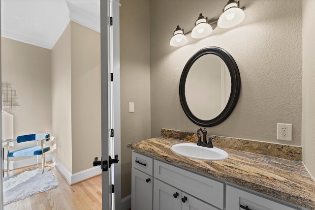 501 Cordell St, Houston, TX 77009 - bathroom with baseboards, ornamental molding, vanity, and wood finished floors