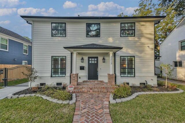 view of front of property with a porch and a front yard