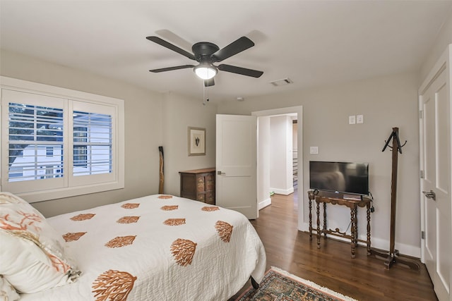 bedroom with dark wood-type flooring and ceiling fan