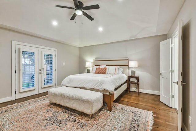 bedroom featuring access to outside, dark hardwood / wood-style floors, ceiling fan, and french doors