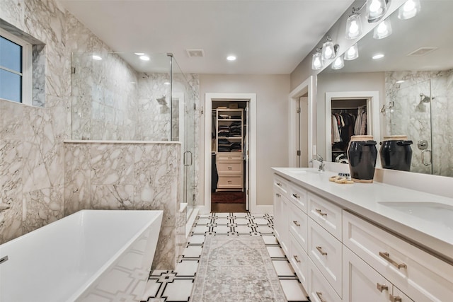 bathroom featuring vanity, independent shower and bath, and tile walls