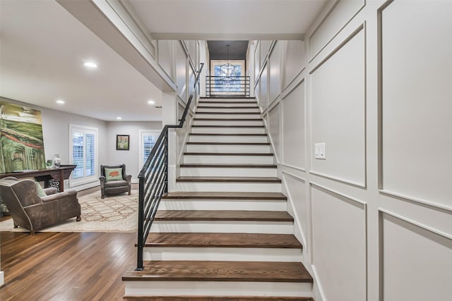 staircase featuring hardwood / wood-style flooring and plenty of natural light