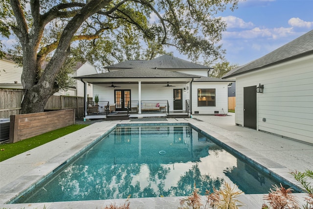 view of swimming pool featuring ceiling fan and a patio