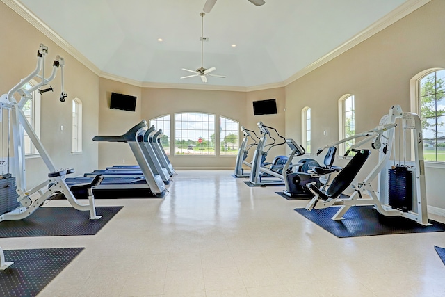 gym with ceiling fan, a high ceiling, and ornamental molding