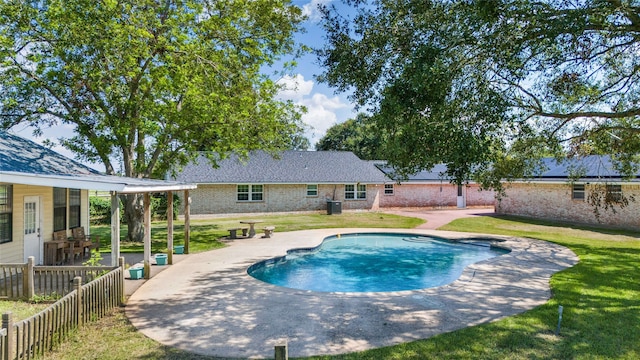 view of pool with a yard, a patio area, and central AC