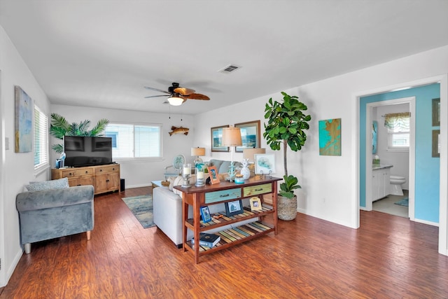 living room with ceiling fan and dark hardwood / wood-style flooring