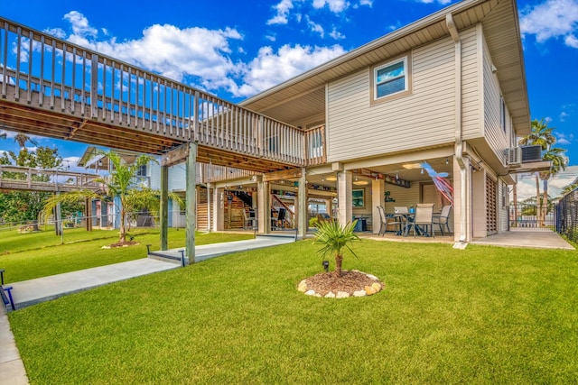 rear view of property featuring a patio, a wooden deck, a lawn, and central AC unit