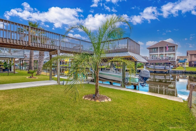 dock area with a water view and a lawn