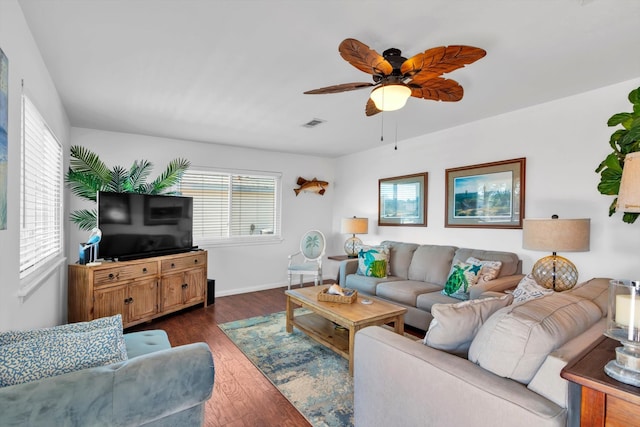 living room with ceiling fan and dark hardwood / wood-style flooring