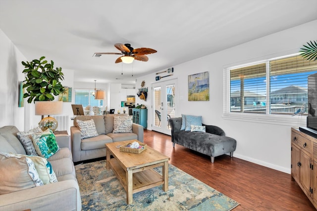 living room with french doors, ceiling fan, a wealth of natural light, and dark hardwood / wood-style flooring