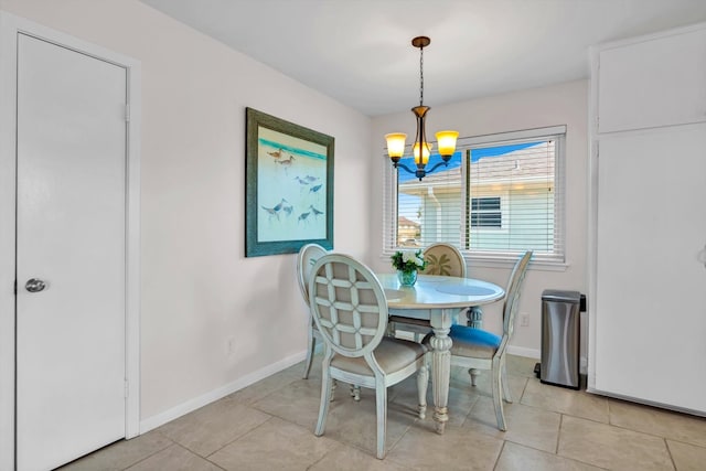 tiled dining space with a notable chandelier