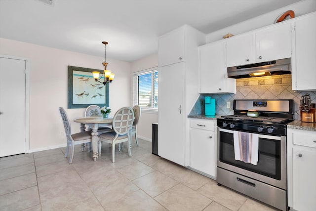 kitchen featuring backsplash, stainless steel gas stove, pendant lighting, white cabinets, and light tile patterned floors