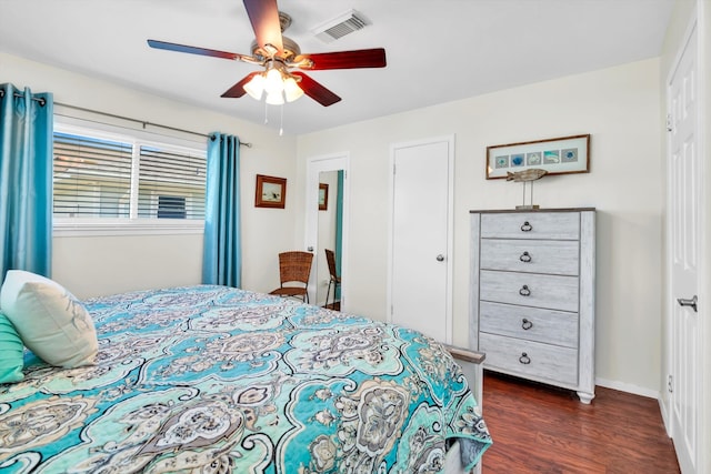 bedroom with dark hardwood / wood-style flooring and ceiling fan