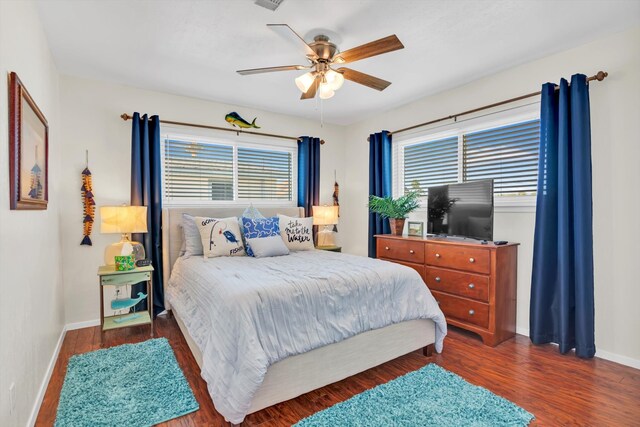 bedroom with dark hardwood / wood-style floors and ceiling fan