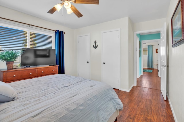 bedroom with ceiling fan and dark hardwood / wood-style flooring