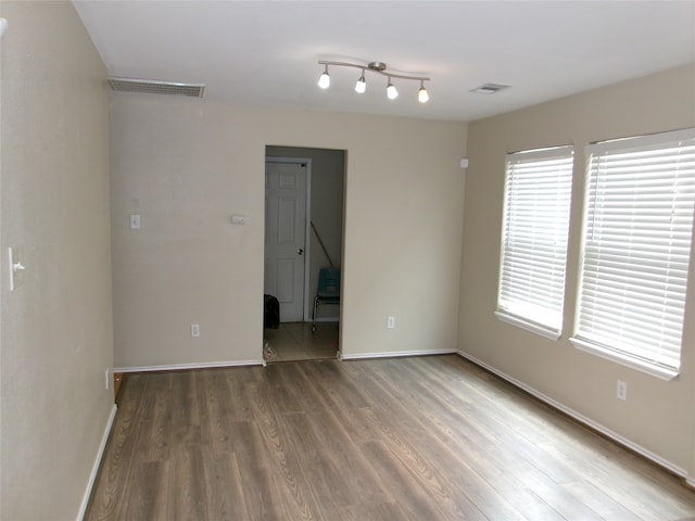 spare room with hardwood / wood-style flooring