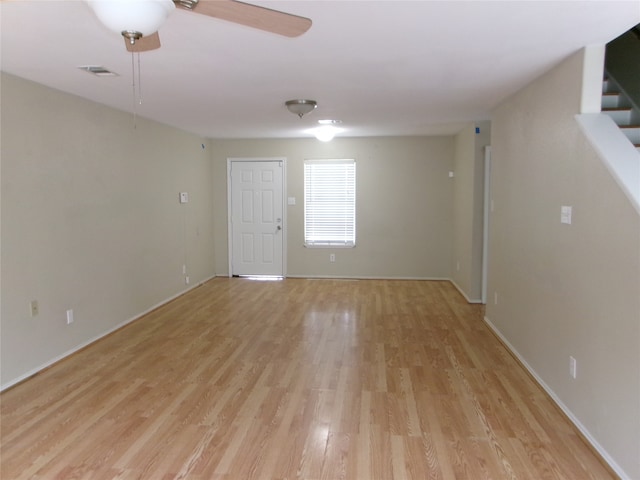 spare room featuring light hardwood / wood-style floors and ceiling fan