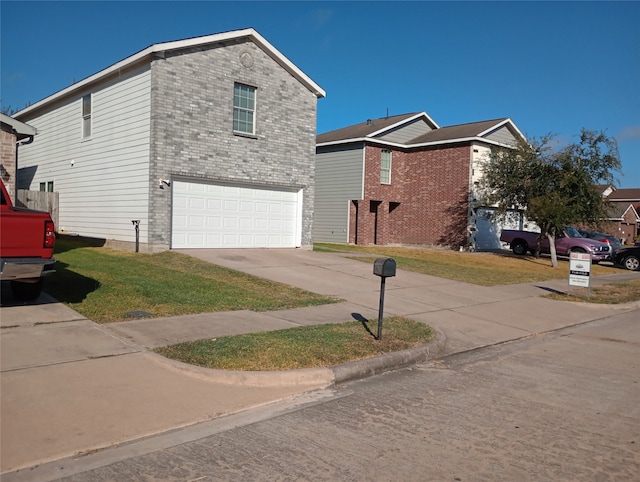 view of side of property with a yard and a garage