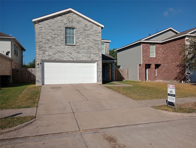 view of property with a front yard and a garage