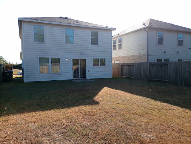 back of house featuring a yard